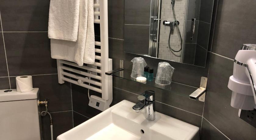 a bathroom with a sink, toilet and shower stall, Alane Hotel in Paris