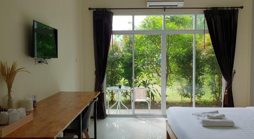 a living room with a large window and a large window, Snooze Inn Phuket in Phuket