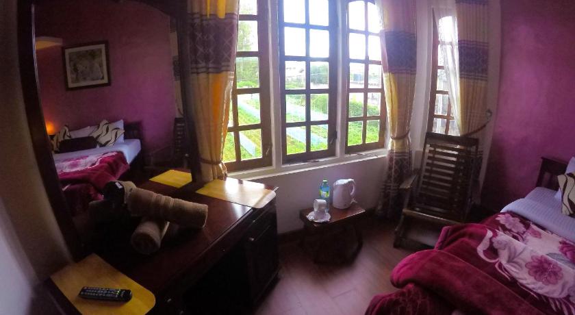 a bedroom with a bed, desk, and window, Nuwara Eliya Hills Rest in Nuwara Eliya