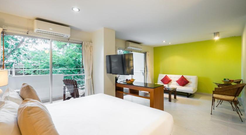 a hotel room with a large bed and a television, Bella Villa Prima Hotel (SHA Plus+) in Pattaya