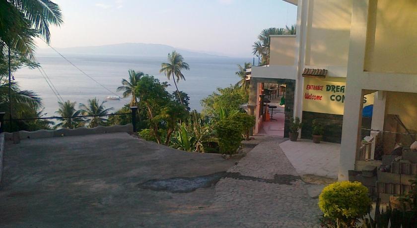 a beach with palm trees and palm trees, Dream Hill Condos & Spa in Puerto Galera