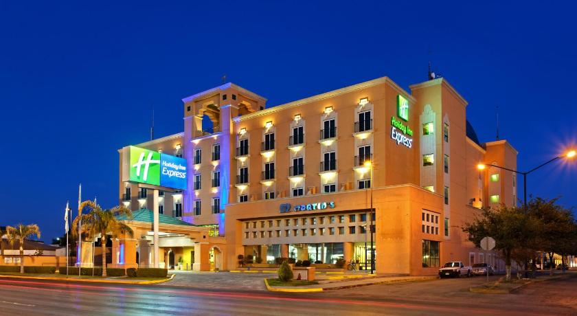 a large building with a clock on the front of it, Holiday Inn Express Torreon in Torreon