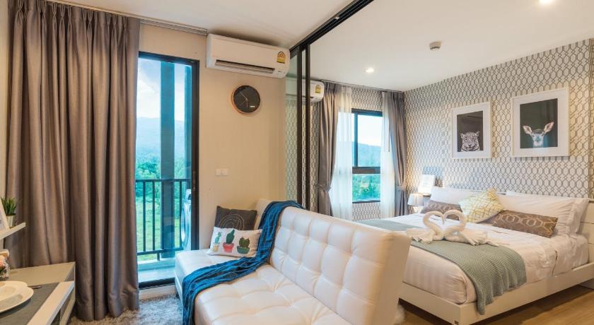 a living room filled with furniture and a window, Zcape Condotel @ Bangtao Beach in Phuket