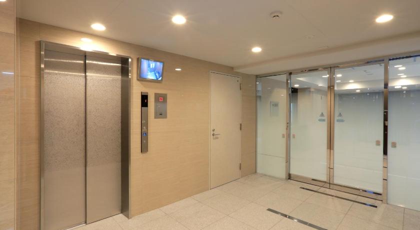 a bathroom with a shower and a walk in shower, Universal Haneda in Tokyo