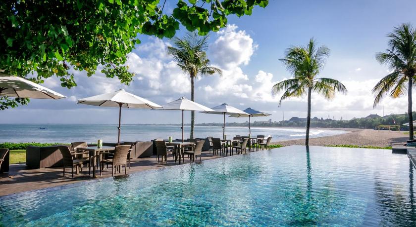 a beach with palm trees and umbrellas, Bali Garden Beach Resort in Bali