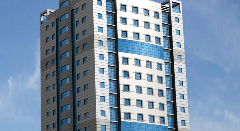 a large building with a clock on top of it, Al Olaya Suites Hotel in Manama