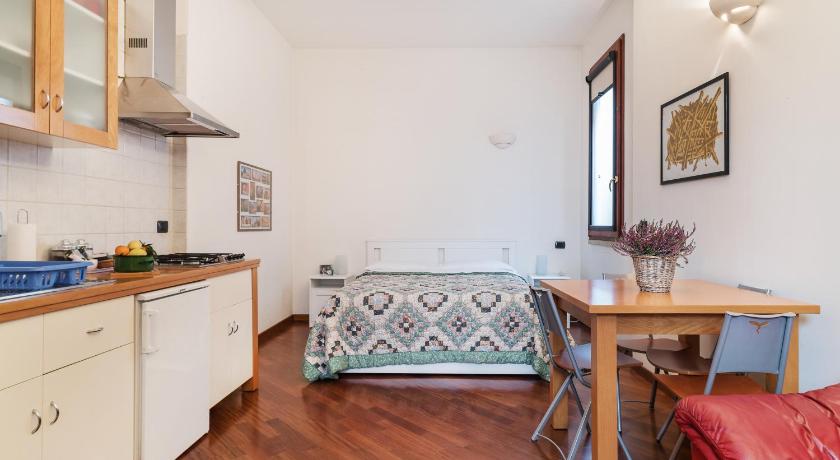 a kitchen with a table, chairs and a refrigerator, Bologna Central Studio in Bologna