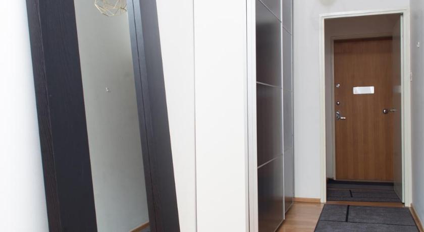 a bathroom with a mirror and a walk in closet, Stay Here Apartment Kamppi in Helsinki
