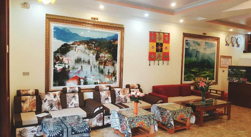 a living room filled with furniture and paintings, Sapa Light Hostel in Sapa