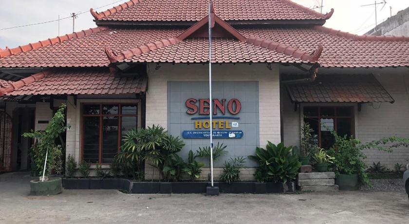 a building with a sign on the front of it, Hotel Seno in Yogyakarta