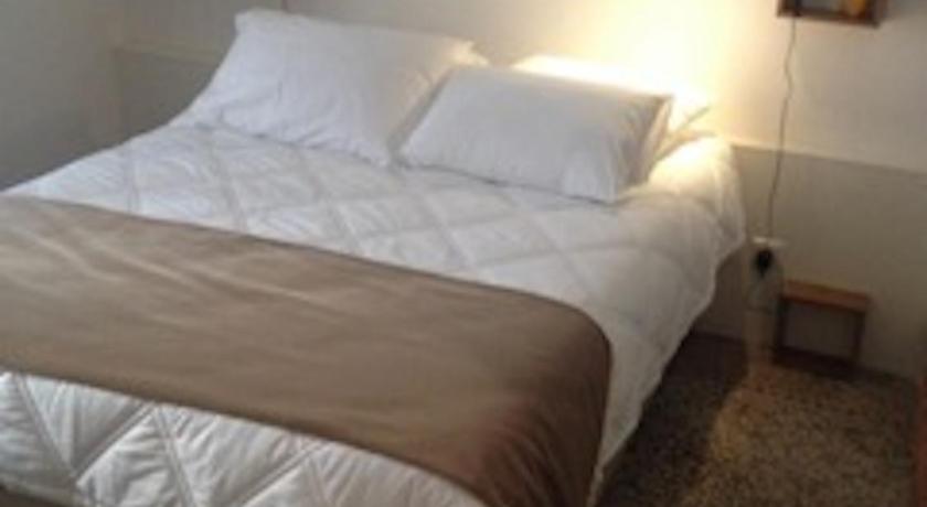 a bed room with a white bedspread and pillows, Ida Chambres d'hotes B&B in Montpellier