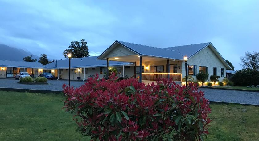 a large house with a large window on the side of the house, High Peaks Hotel in Fox Glacier
