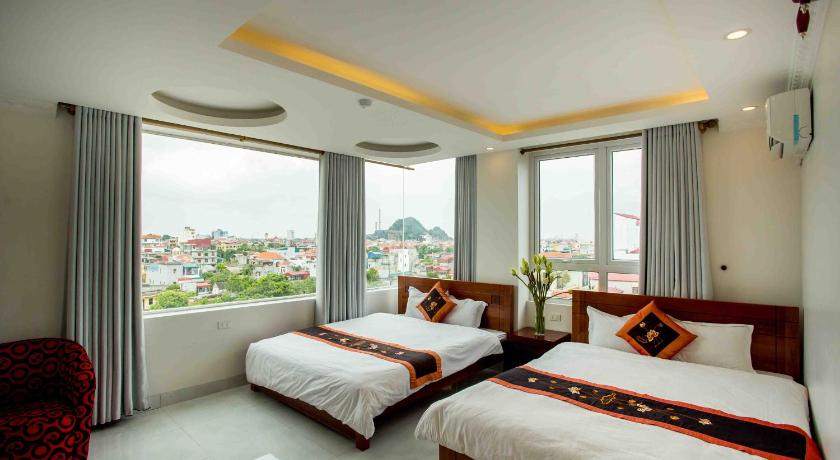 a hotel room with two beds and two windows, Van Hoa Ninh Binh Hotel in Ninh Bình