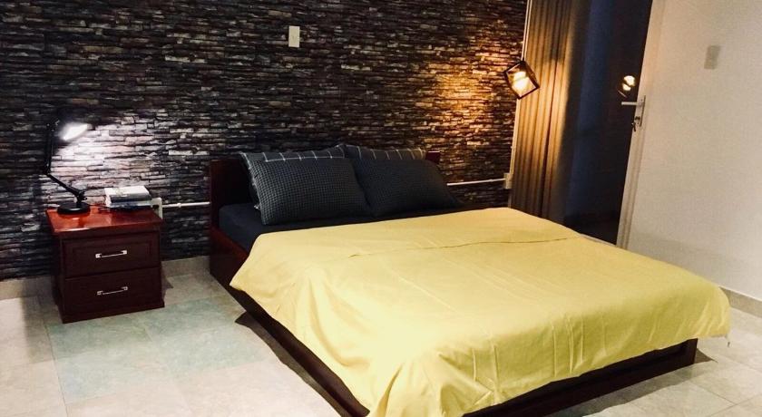 a bedroom with a large bed and a large window, 08 Homestay in Cần Thơ