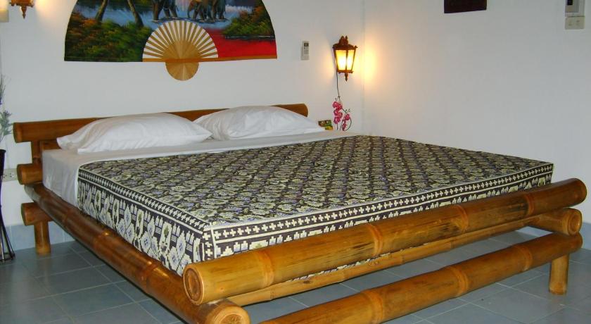 a bed with a white bedspread and pillows in a room, Home Paradise Resort Tak in Tak