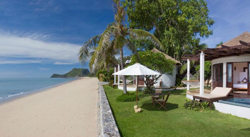 a beach with a lawn chair and patio area, Aleenta Hua Hin - Pranburi Resort & Spa (SHA Plus+) in Hua Hin / Cha-am