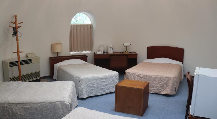 a hotel room with two beds and a desk, The Hirosawa City Domehouse in Chikusei
