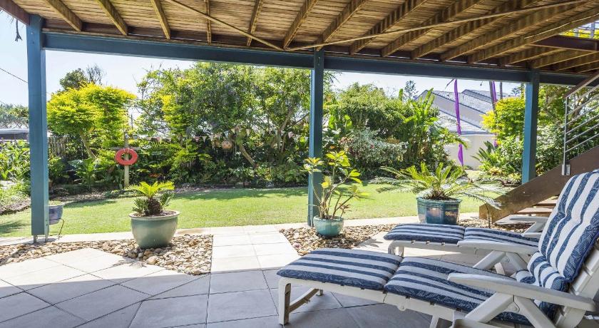 a patio area with chairs, tables and umbrellas, Moana Retreat in Lennox Head