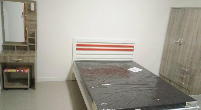 a bed that is in a room, Sands Place Apartment and Hotel in Samut Sakhon