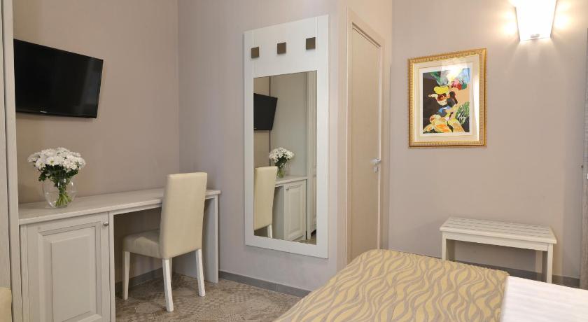 a hotel room with a bed and a mirror, Residenza del Corso in Matera