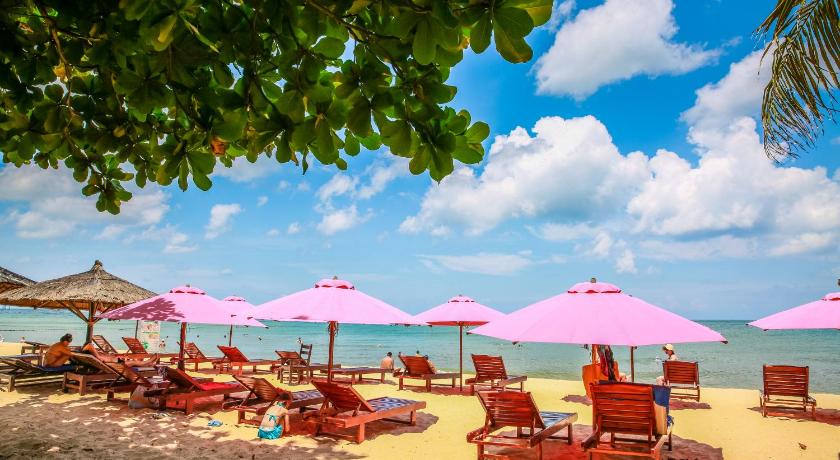 a beach area with umbrellas and chairs, Arcadia Phu Quoc Resort in Phu Quoc Island