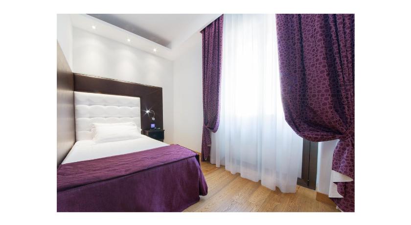 a bedroom with a bed and a television, Hotel Royal Caserta in Caserta