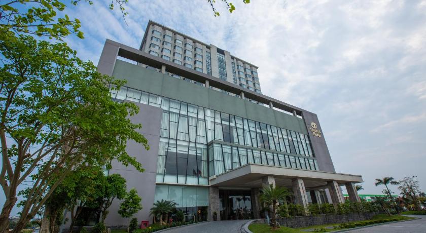 a large building with a clock on the side of it, Central Hotel Thanh Hoa in Thanh Hoá / Sầm Sơn Beach