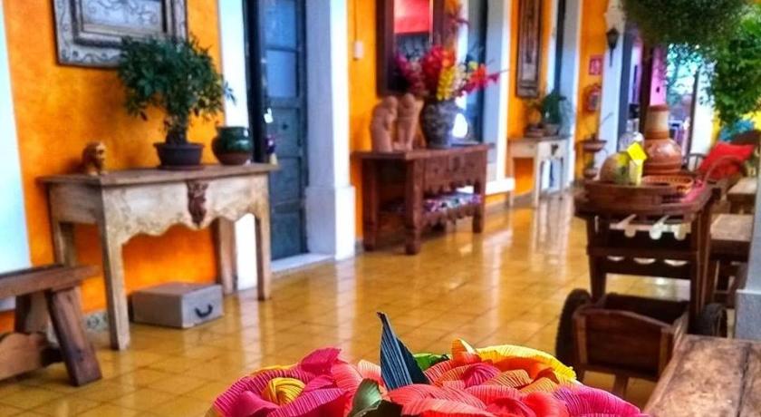 a living room filled with furniture and flowers, Casona Tlaquepaque Temazcal & Spa in Guadalajara
