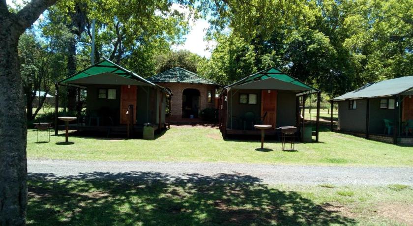 a green and white house with trees, Sabie River Camp in Sabie