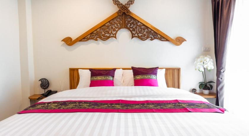 a bed with a white bedspread and pillows, Anumat Premium Budget Hotel in Chiang Mai