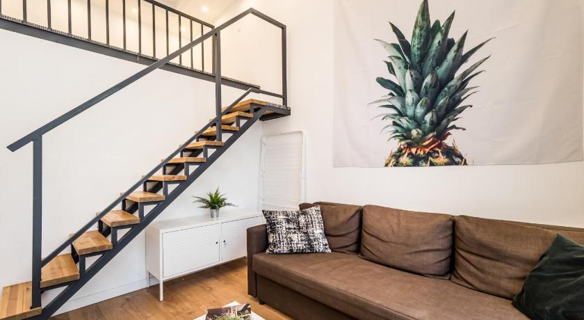a living room filled with furniture and a staircase, Hello Downtown Apartment - Boulevard in Budapest