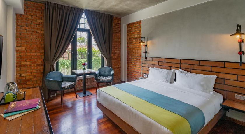 a bedroom with a large bed and a large window, Treasures Hotel and Suites in Malacca