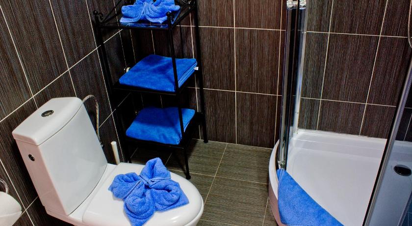 a bathroom with a toilet, sink, and shower stall, Royal Court Apartments in Prague