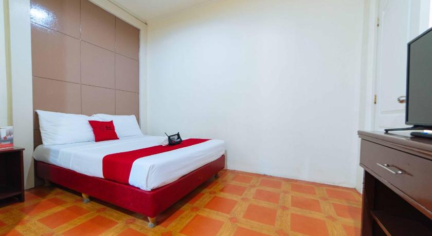 a hotel room with a bed and a television, RedDoorz near Walking Street Angeles City in Angeles / Clark