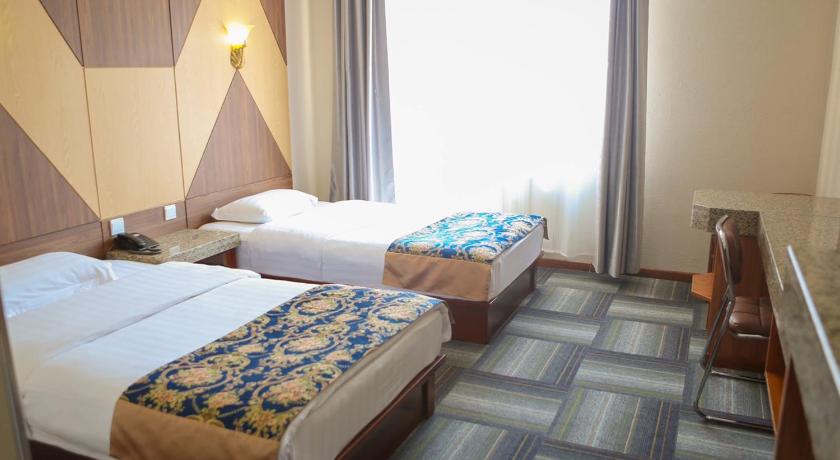 a hotel room with two beds and a desk, Zolo Hotel in Ulaanbaatar