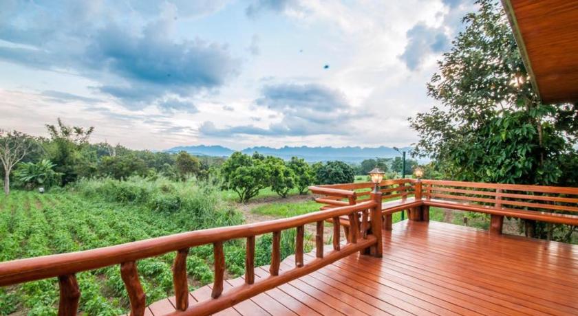 a wooden deck with a view of the water, ม่อนชมดอย in Chiang Dao