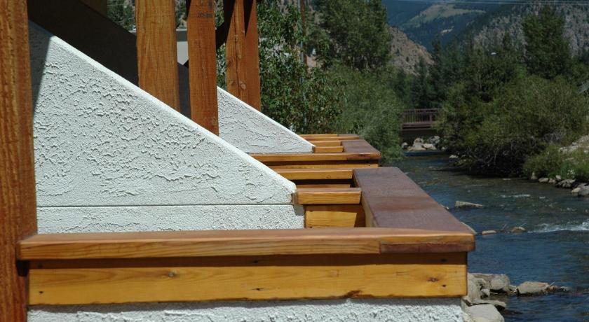 a row of wooden benches sitting on top of a river, Hotel Chateau Chamonix in Georgetown (CO)
