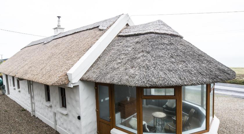 a house with a wooden roof and a window, Storytellers Cottage in Doolin