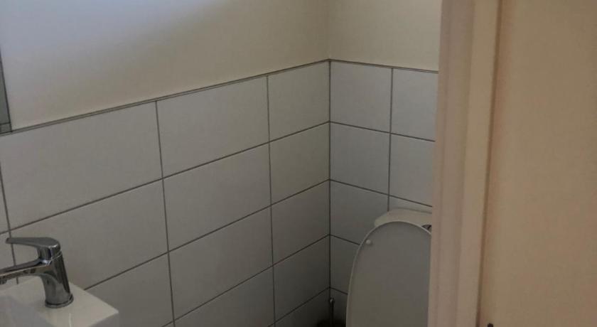 a white toilet sitting next to a white sink, Waitaki Lakes Apartments - Otematata in Otematata
