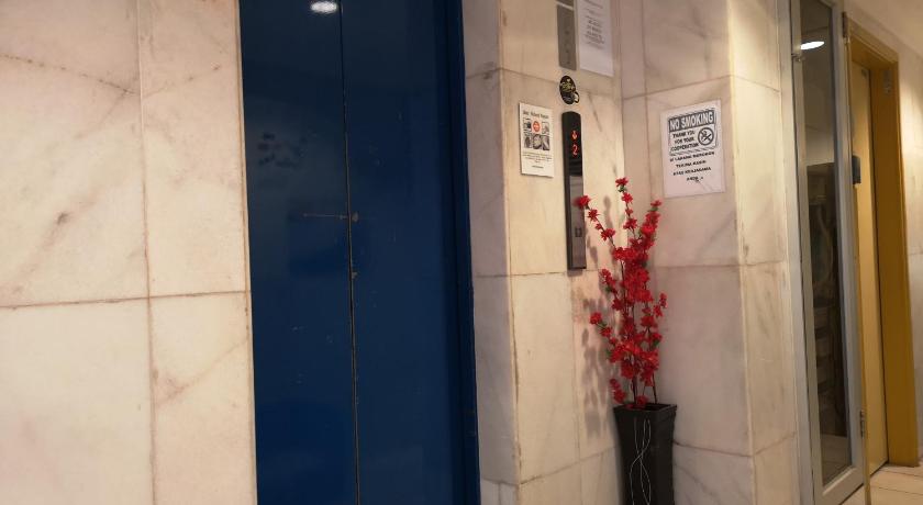 a blue door with a red and white sign on it, HOTEL AMBASSADOR 1 in Labuan
