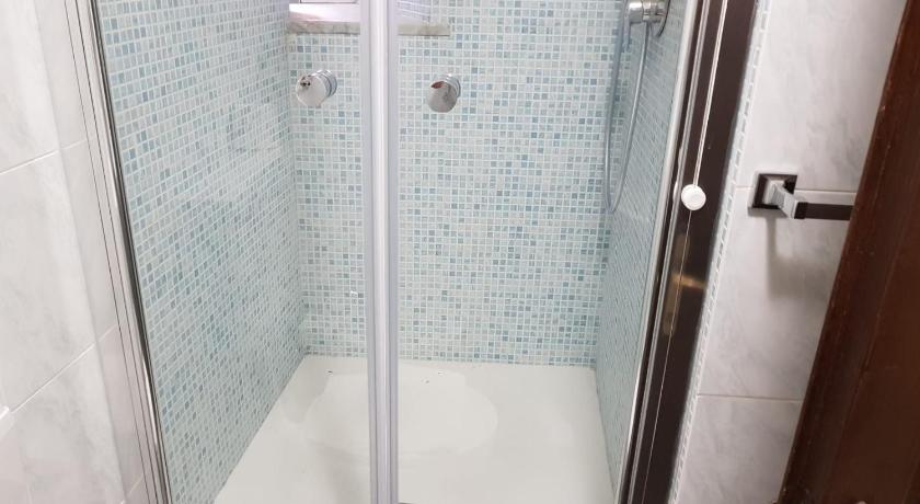 a shower stall with a glass shower door, Vento di Grecale in Riomaggiore