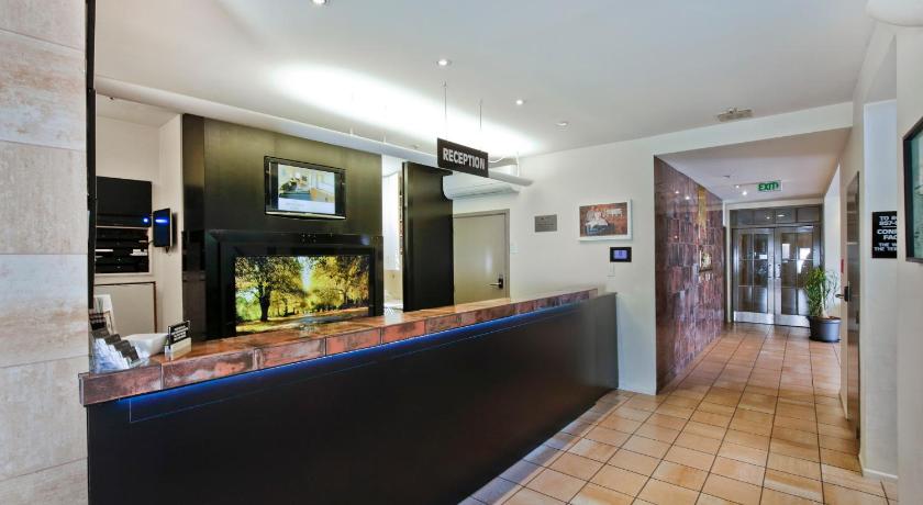 a restaurant with a bar and a large window, Pavilions Hotel in Christchurch