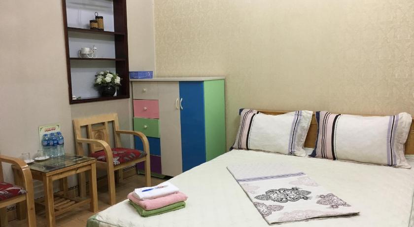 a bedroom with a bed and a desk, Homestay A1 in Dien Bien Phu