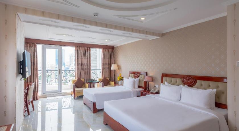 a hotel room with two beds and a large window, Bon Ami Hotel - Thiên Xuân Hotel in Ho Chi Minh City