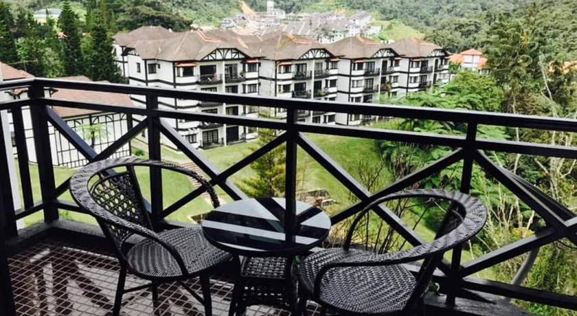a patio area with chairs and a balcony, Cameron Greenhill Apartment in Cameron Highlands