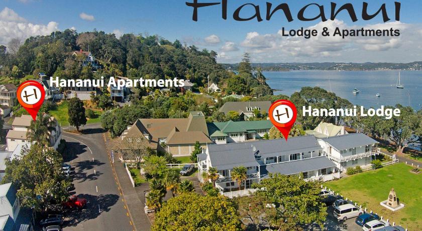 a view from a boat of a city with houses and trees, Hananui Lodge & Apartments in Bay of Islands