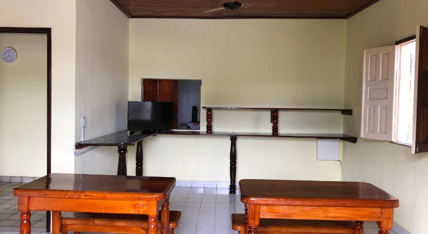 a kitchen area with a table and chairs, Hostel Beach in Porto Seguro