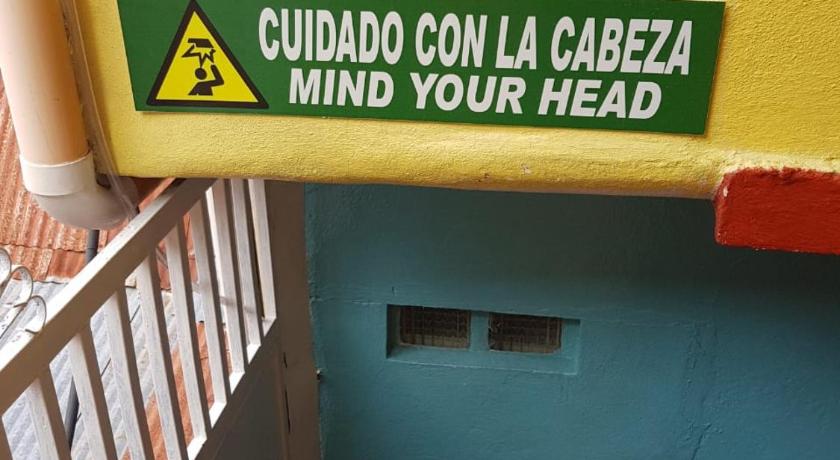 a sign on the side of a building, Hotel Posada Tayazal in Flores