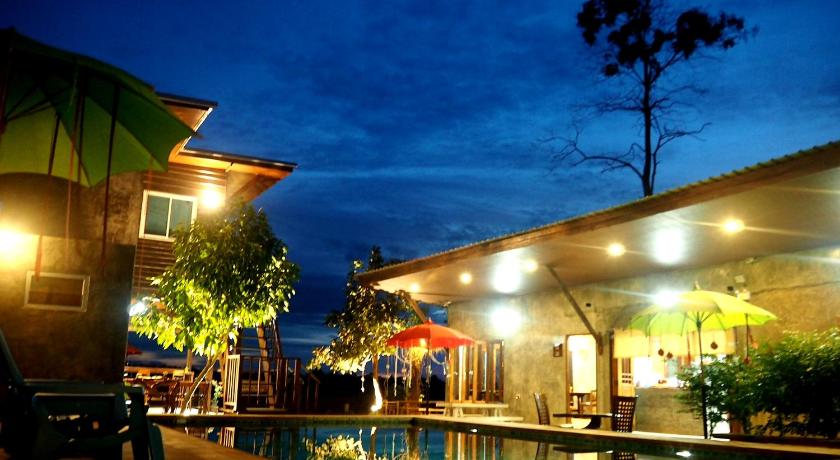a patio area with a pool, chairs, and umbrellas, Nawiengkae Riverview Resort in Mukdahan