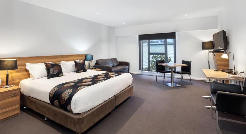 a hotel room with a large bed and a large window, Best Western Plus Ballarat Suites in Ballarat